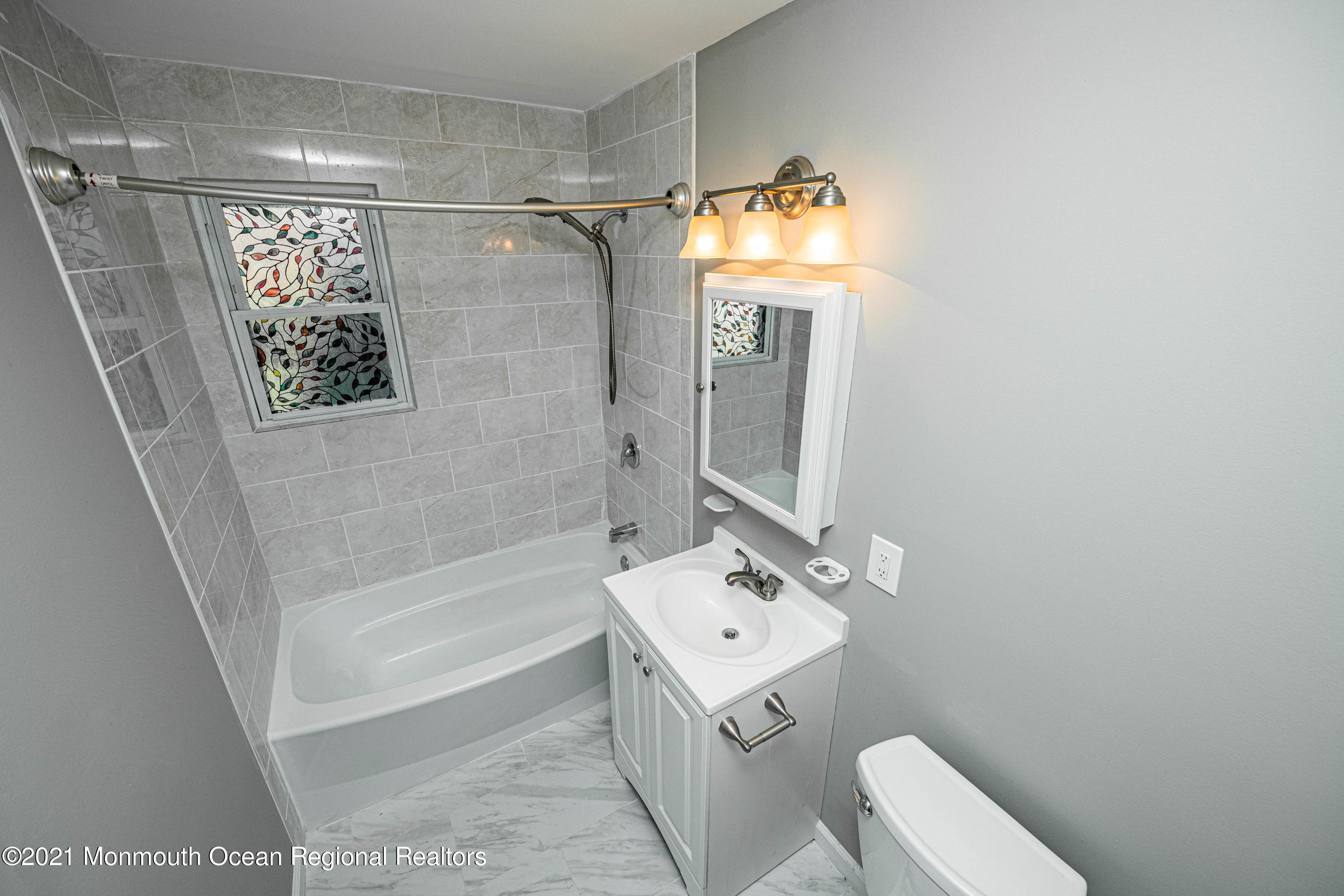 59 Stonehurst Boulevard, Unit B Freehold, NJ 07728 - Photo 14 of 25 a bathroom with a sink a toilet and shower