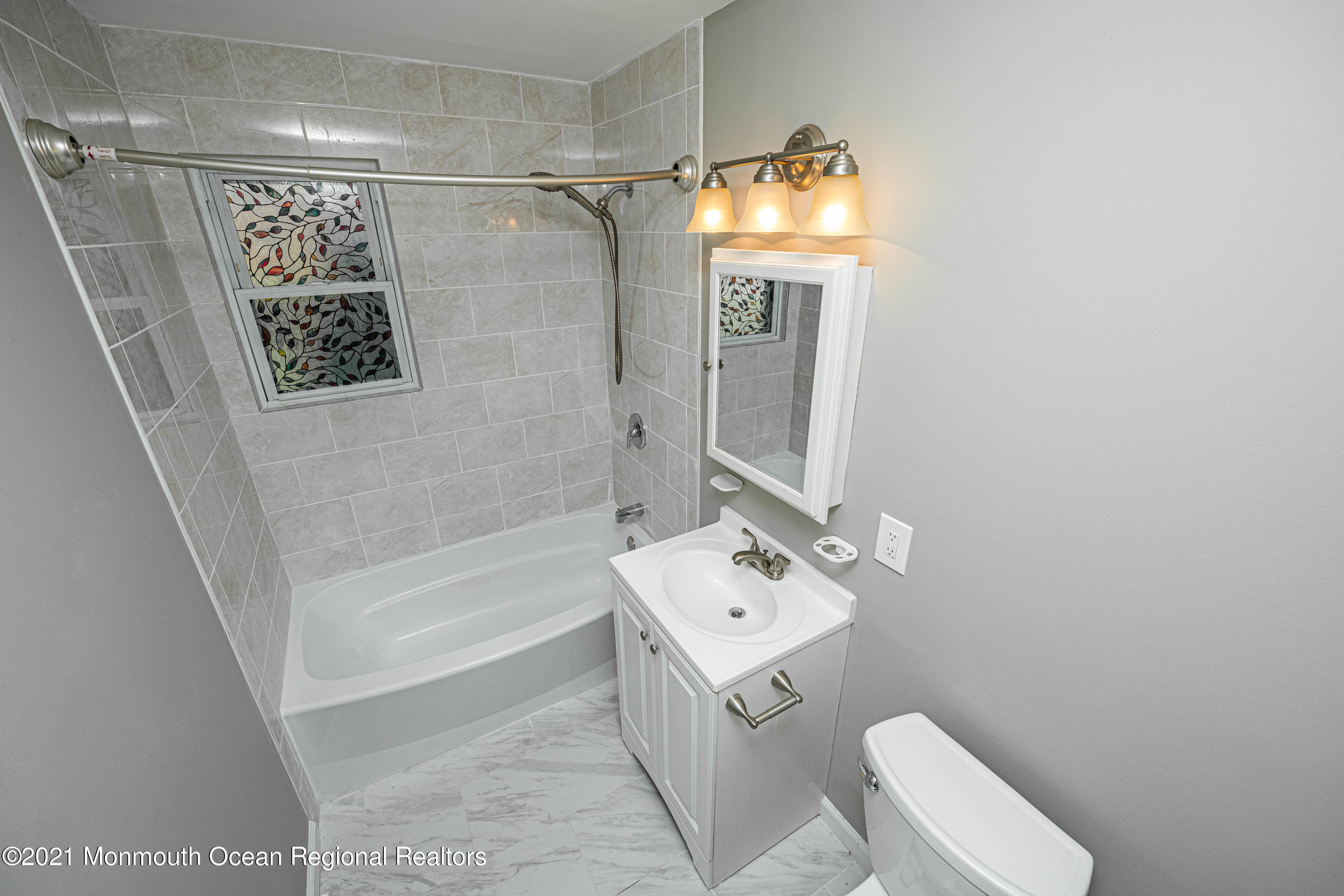 59 Stonehurst Boulevard, Unit B Freehold, NJ 07728 - Photo 15 of 25 a bathroom with a sink a toilet and shower