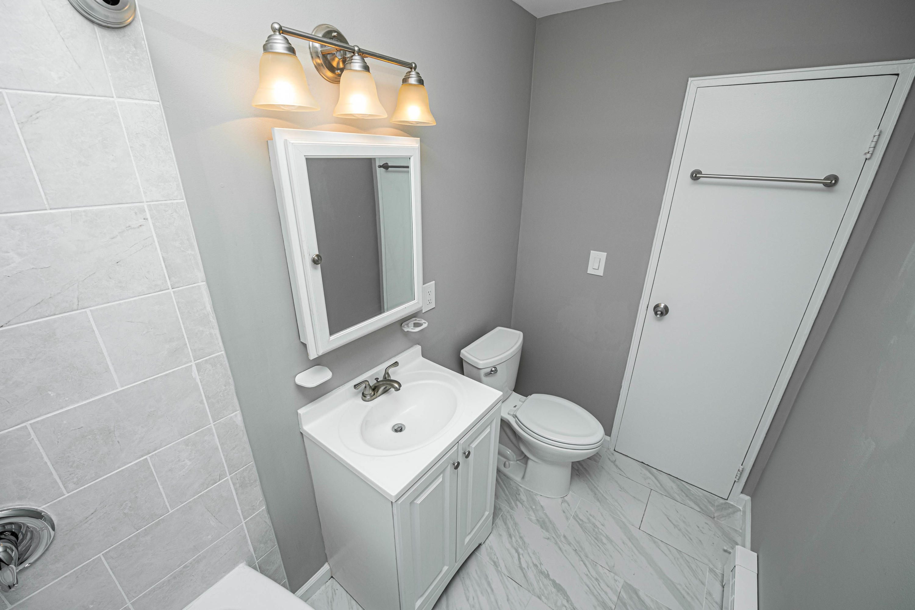 59 Stonehurst Boulevard, Unit B Freehold, NJ 07728 - Photo 16 of 25 a bathroom with a toilet sink and mirror