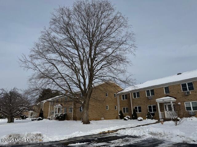 59 Stonehurst Boulevard, Unit B Freehold, NJ 07728 - Photo 2 of 25 a front view of a building with trees