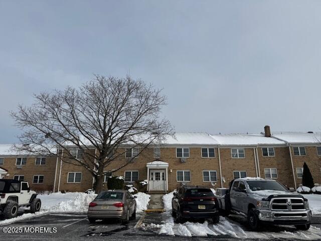 59 Stonehurst Boulevard, Unit B Freehold, NJ 07728 - Photo 23 of 25 a front view of a house with cars parked