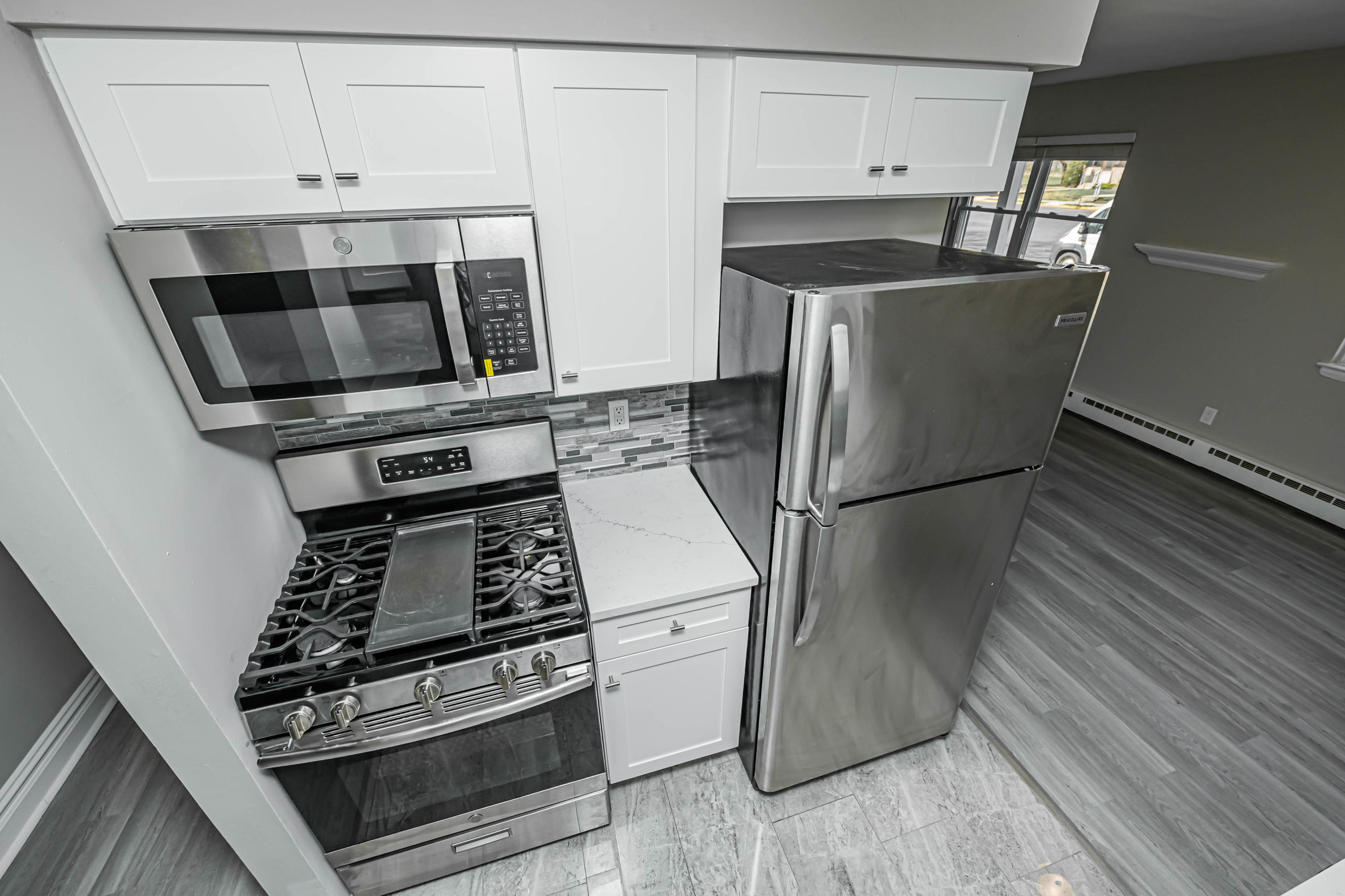 59 Stonehurst Boulevard, Unit B Freehold, NJ 07728 - Photo 4 of 25 a kitchen with appliances and cabinets