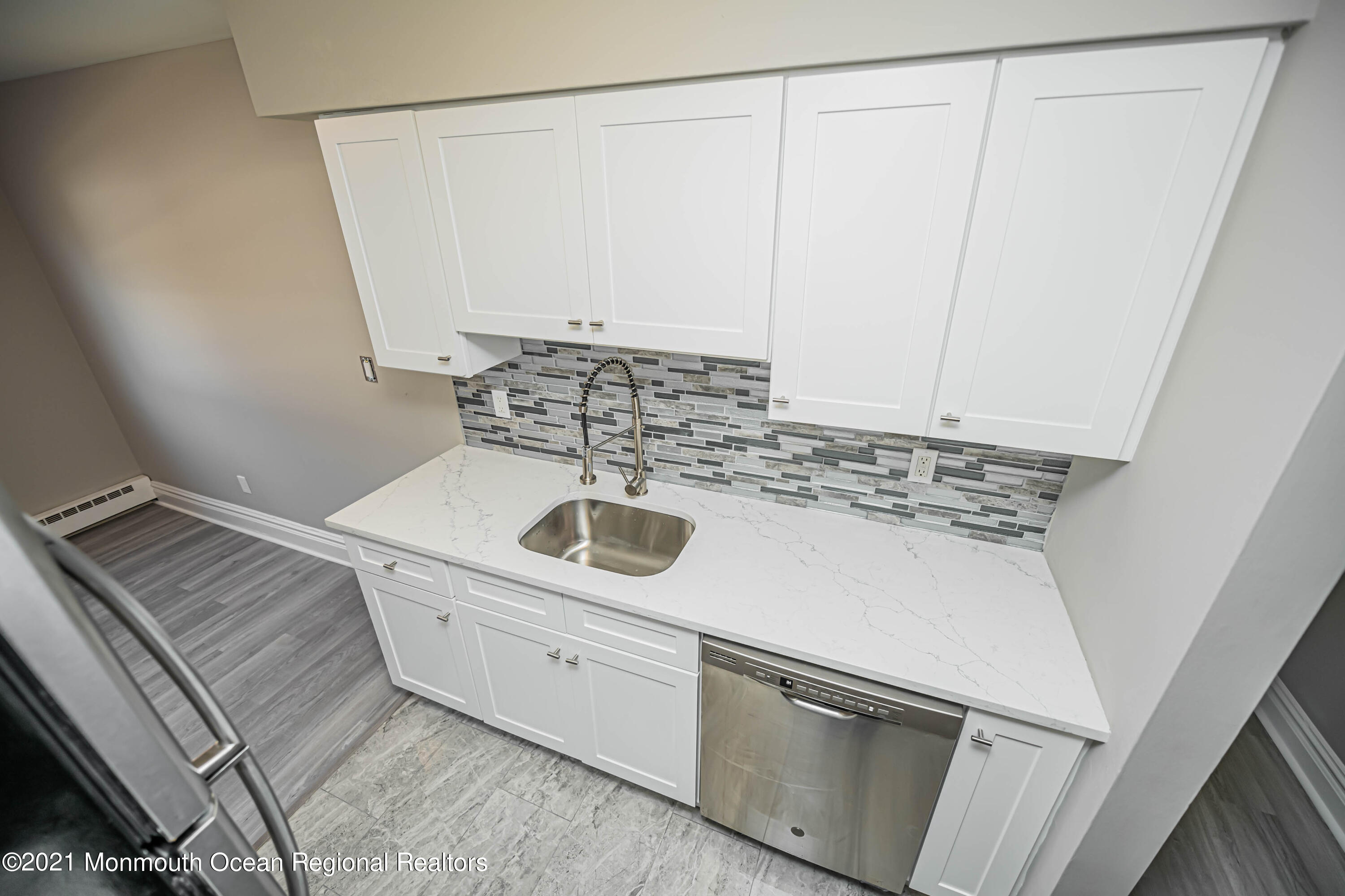 59 Stonehurst Boulevard, Unit B Freehold, NJ 07728 - Photo 5 of 25 a close view of a sink a washer and dryer