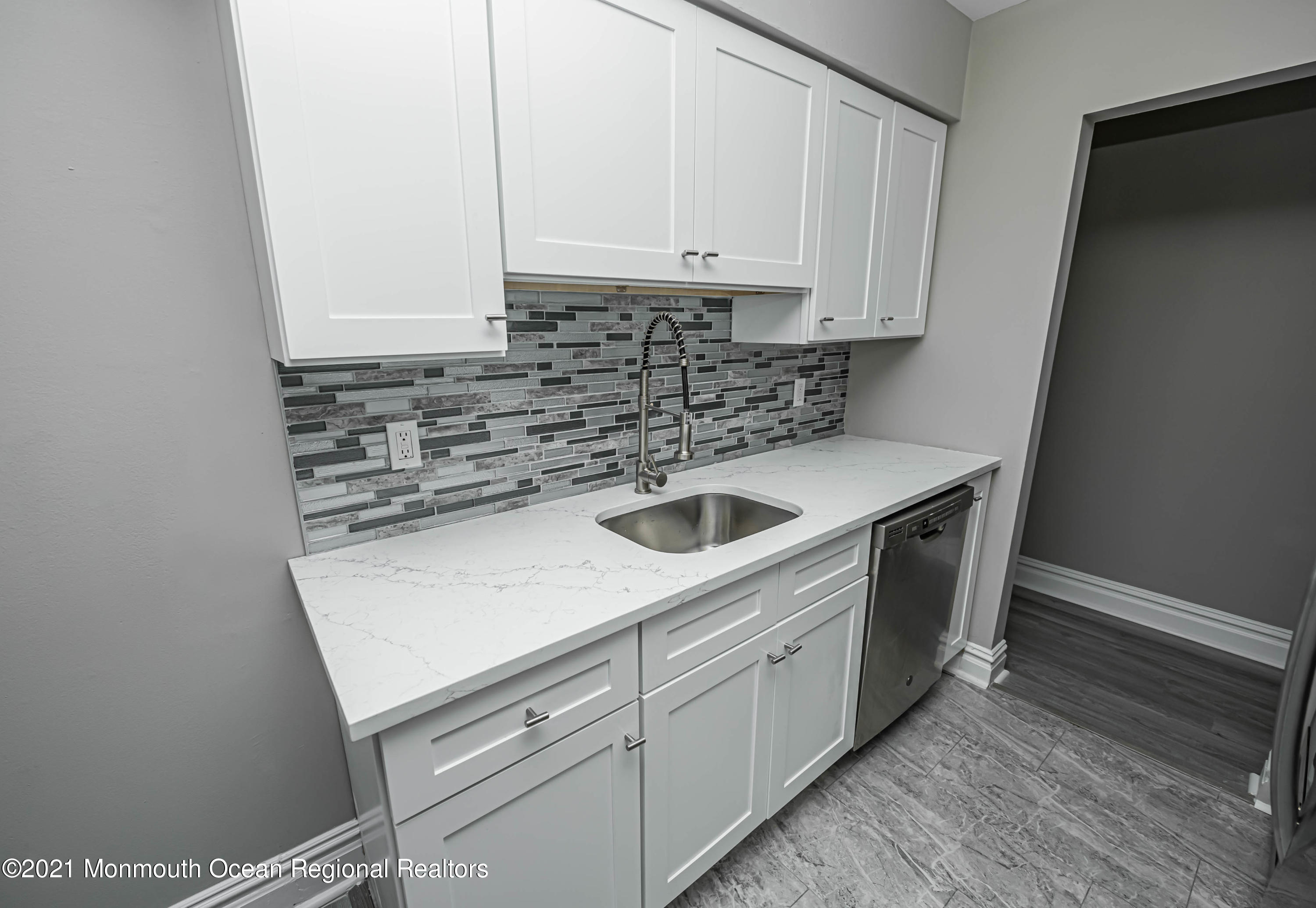 59 Stonehurst Boulevard, Unit B Freehold, NJ 07728 - Photo 6 of 25 a kitchen with a sink and cabinets