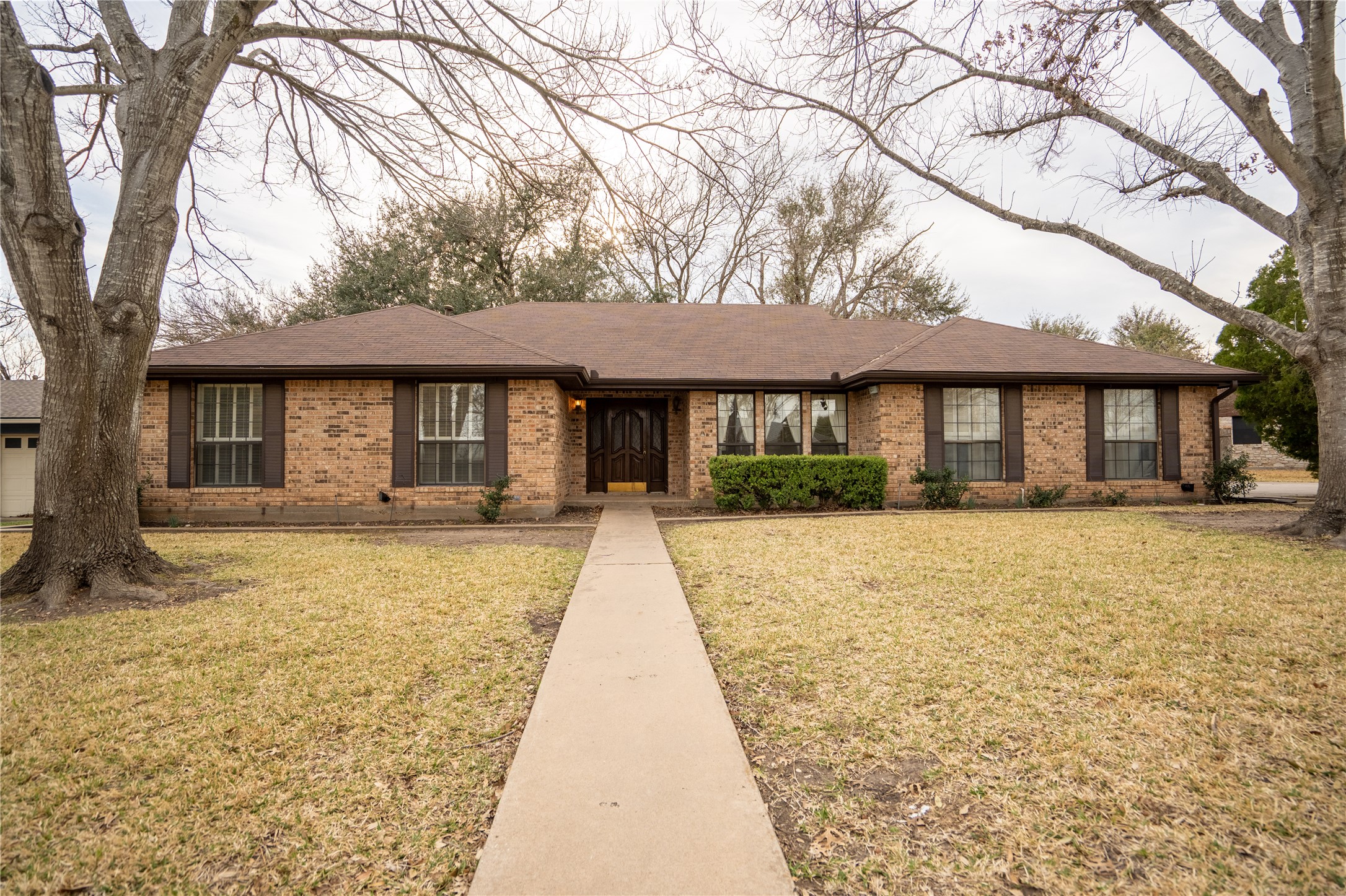 a front view of a house with a garden