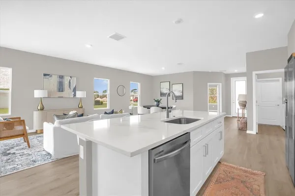 a kitchen with sink stove and view living room