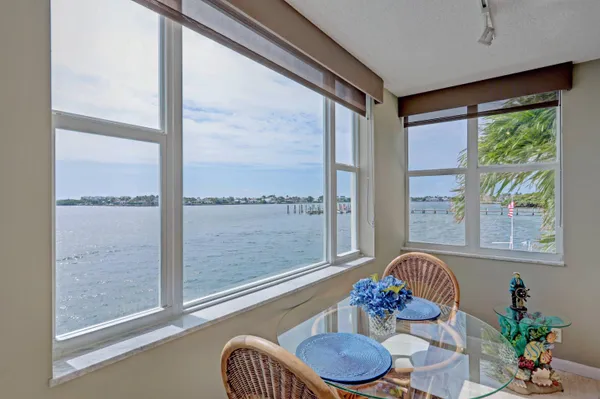 a view of a dining room with furniture large windows and wooden floor