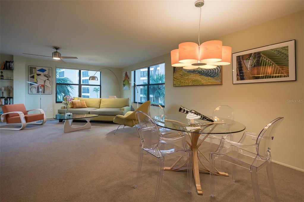 5780 Midnight Pass Road, Unit 210 Sarasota, FL 34242 - Photo 25 of 58 a living room with furniture and a chandelier