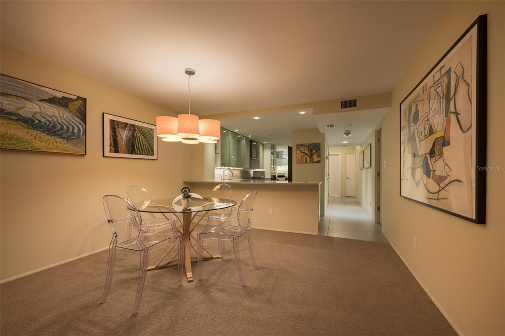 5780 Midnight Pass Road, Unit 210 Sarasota, FL 34242 - Photo 26 of 58 a view of a dining room with furniture and a kitchen