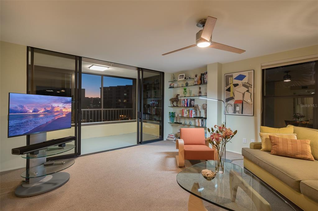 5780 Midnight Pass Road, Unit 210 Sarasota, FL 34242 - Photo 27 of 58 a living room with furniture and a flat screen tv