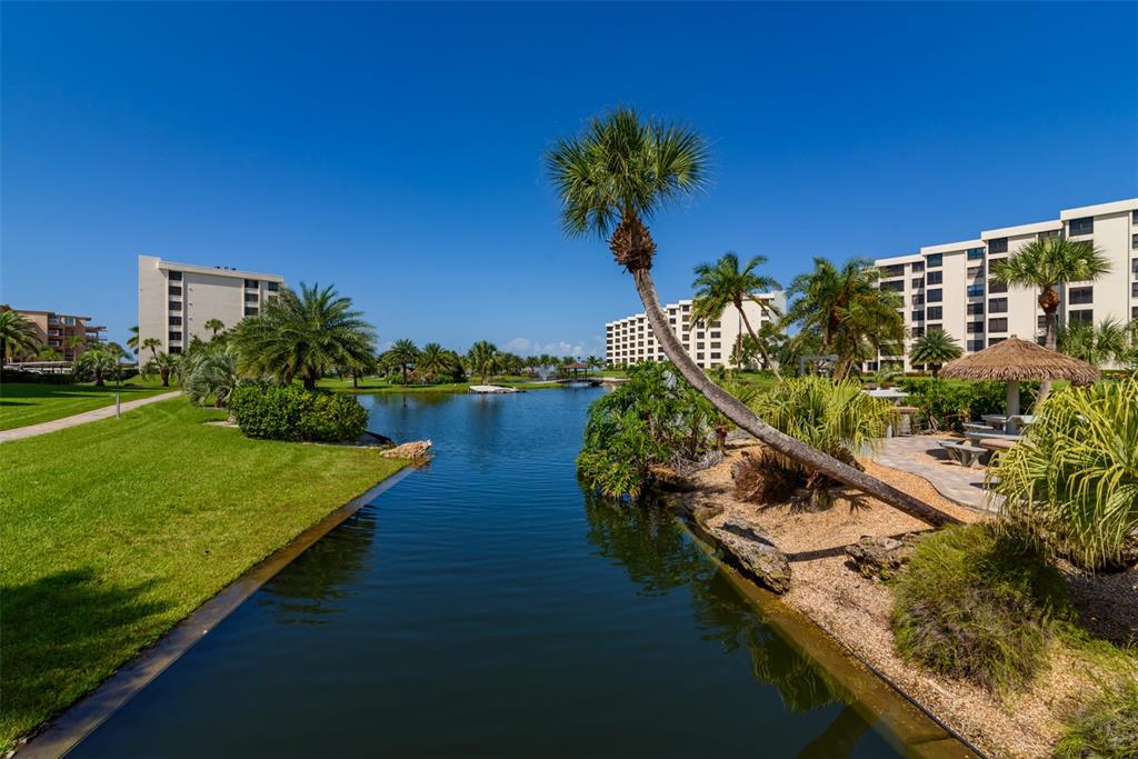 5780 Midnight Pass Road, Unit 210 Sarasota, FL 34242 - Photo 39 of 58 a view of a lake with a building in the background