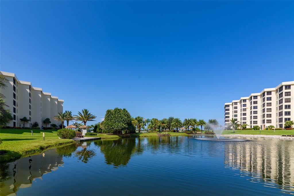 5780 Midnight Pass Road, Unit 210 Sarasota, FL 34242 - Photo 46 of 58 a view of a lake with houses