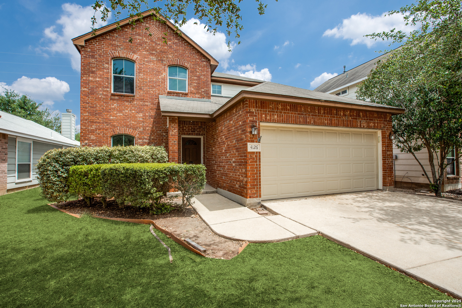 a front view of a house with a yard and garage