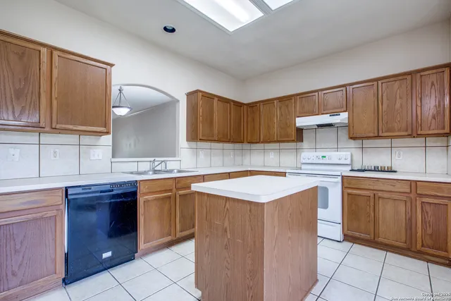 a kitchen with stainless steel appliances granite countertop a sink counter space cabinets and a sink