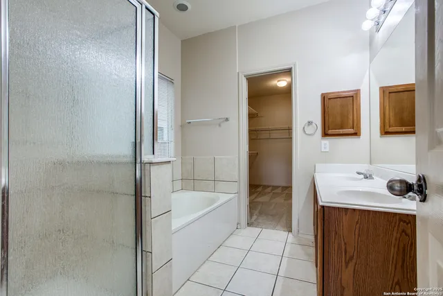 a bathroom with a bathtub sink and mirror