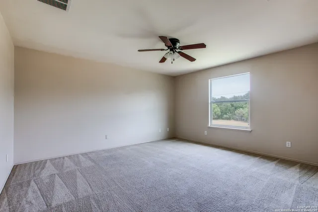 a view of room with a ceiling fan and hardwood floor