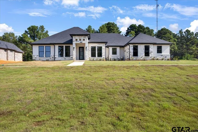 a front view of a house with swimming pool having outdoor seating