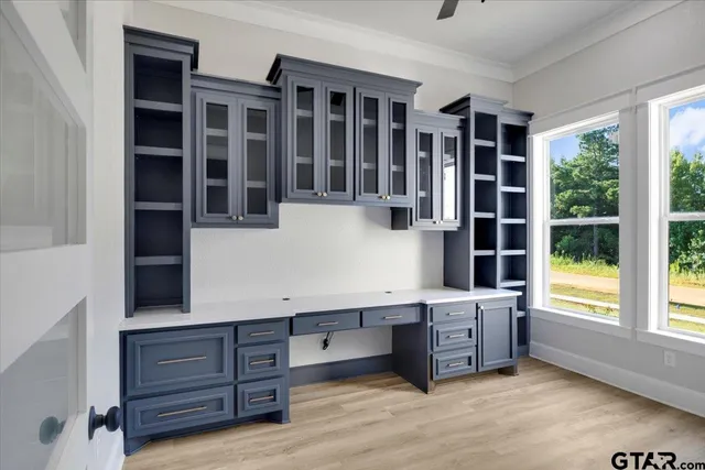 a view of a kitchen with a sink and wooden floor