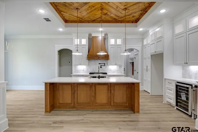 a kitchen with a sink a stove a refrigerator and a cabinets