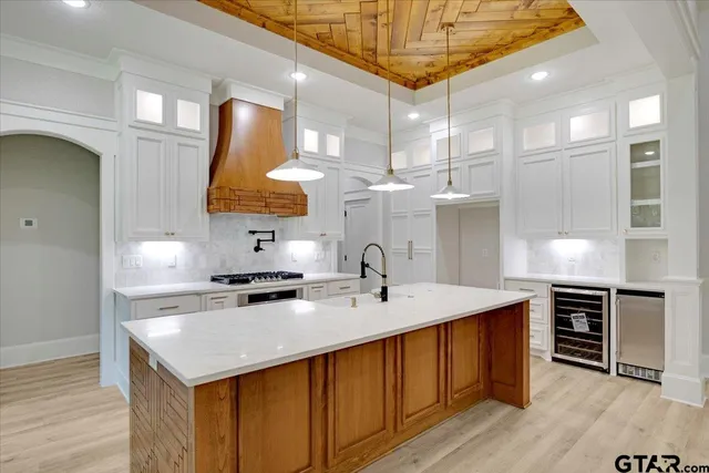 a kitchen with a sink appliances and cabinets