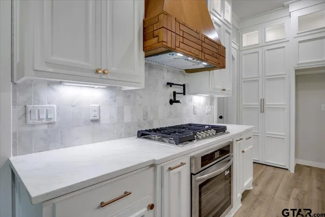 a kitchen with a sink cabinets and wooden floor