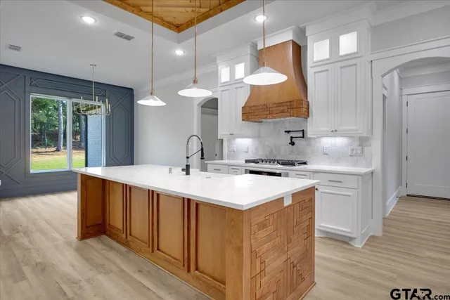 a kitchen with a sink and chandelier