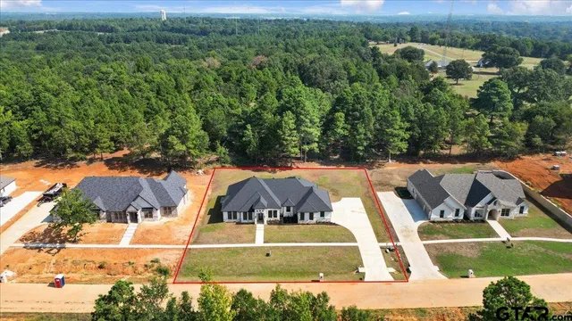 an aerial view of a house with a yard