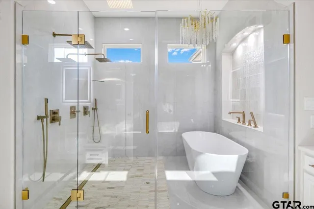 a bathroom with a granite countertop sink vanity and mirror