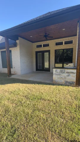 a view of a swimming pool with outdoor seating and a yard