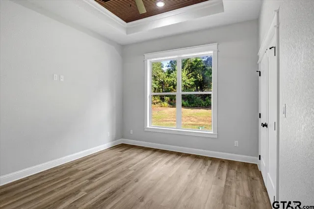 a view of empty room with wooden floor