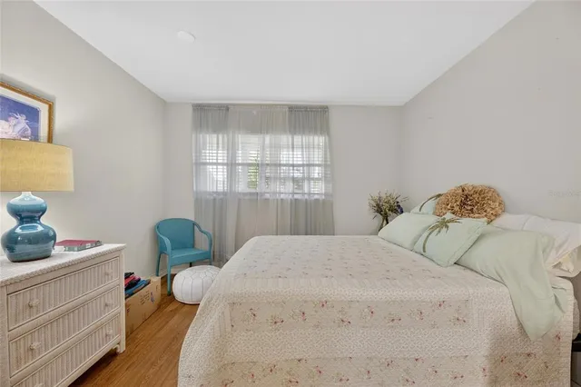 a bedroom with a bed a mirror and desk