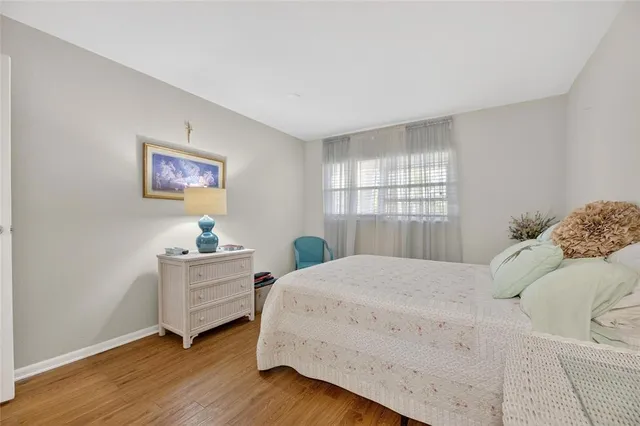 a bedroom with a bed mirror and a window