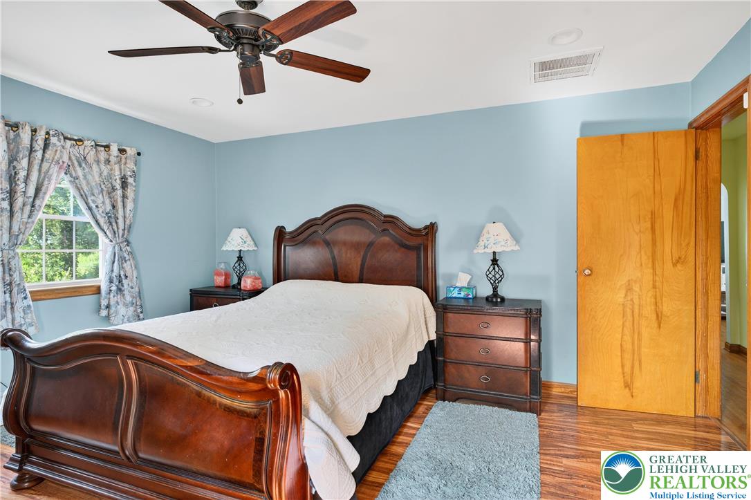 4164 Hecktown Road Bethlehem, PA 18020 - Photo 11 of 39 a bedroom with a bed and wooden floor