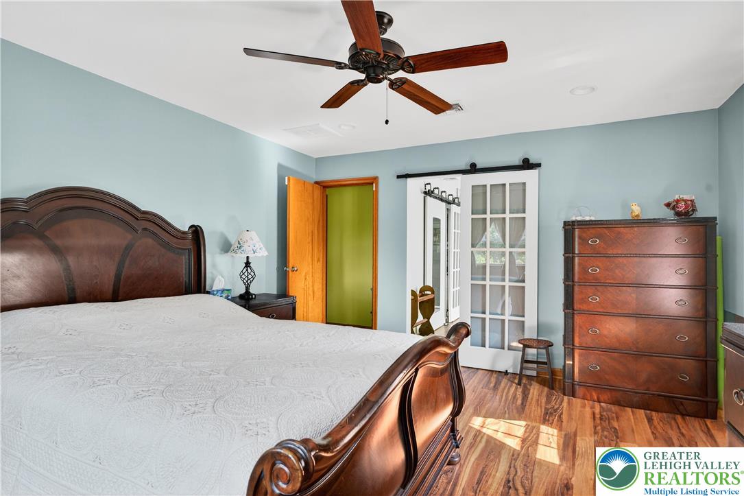 4164 Hecktown Road Bethlehem, PA 18020 - Photo 12 of 39 a bedroom with a bed and a chandelier