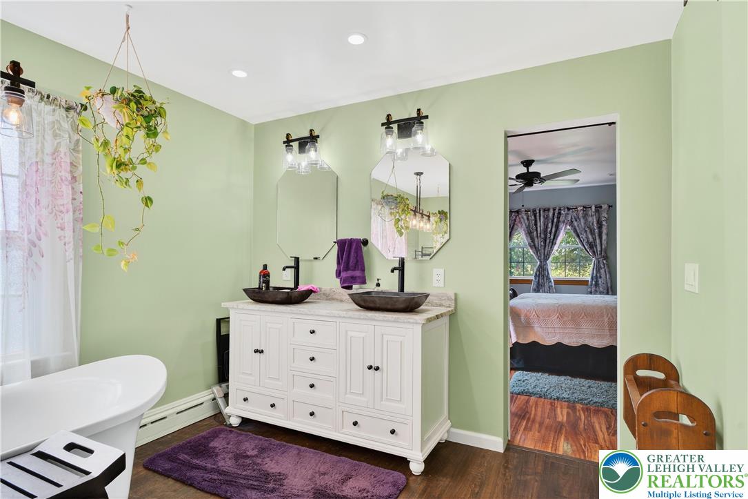 4164 Hecktown Road Bethlehem, PA 18020 - Photo 15 of 39 a bathroom with a sink a toilet and a mirror