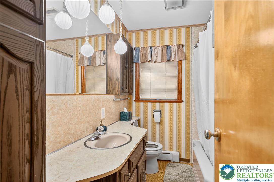 4164 Hecktown Road Bethlehem, PA 18020 - Photo 18 of 39 a bathroom with a sink a toilet and a mirror
