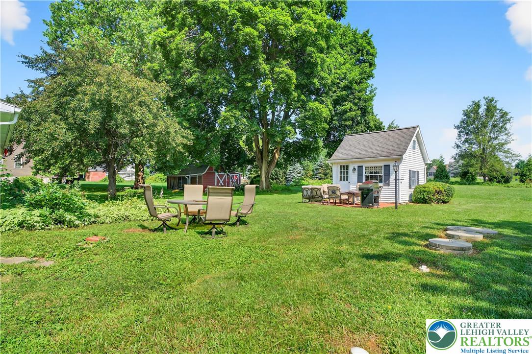 4164 Hecktown Road Bethlehem, PA 18020 - Photo 26 of 39 a view of a chair and table in backyard of the house