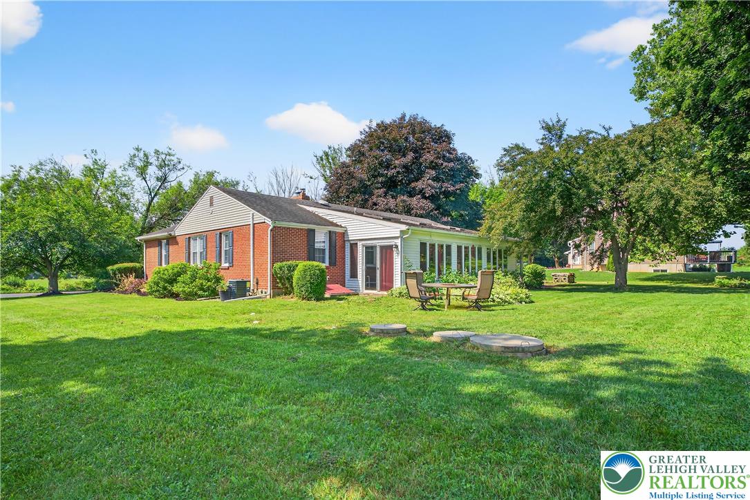 4164 Hecktown Road Bethlehem, PA 18020 - Photo 27 of 39 a front view of a house with a yard table and chairs