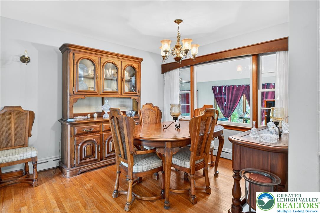 4164 Hecktown Road Bethlehem, PA 18020 - Photo 6 of 39 a view of a dining room with furniture a chandelier and wooden floor