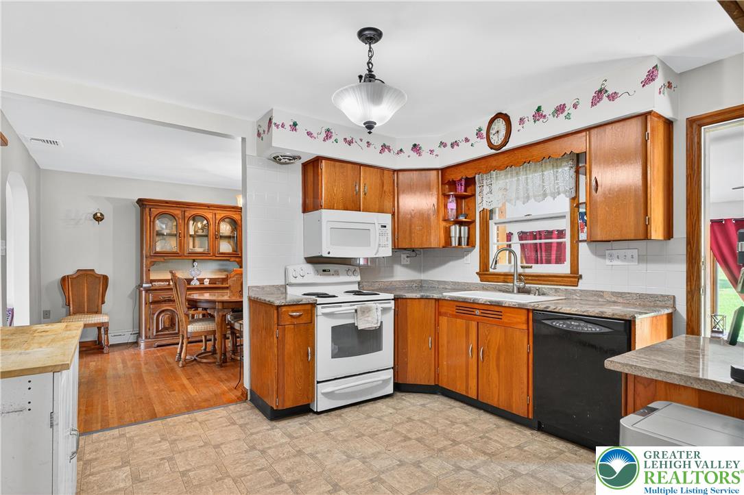 4164 Hecktown Road Bethlehem, PA 18020 - Photo 8 of 39 a kitchen with stainless steel appliances granite countertop a sink stove and refrigerator