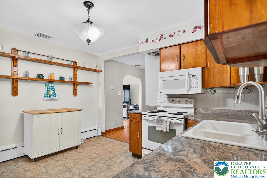 4164 Hecktown Road Bethlehem, PA 18020 - Photo 9 of 39 a kitchen with stainless steel appliances granite countertop a sink stove and refrigerator