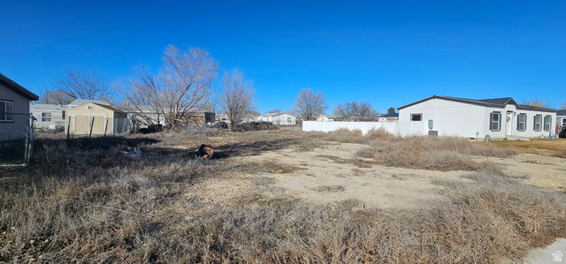 230 Maple Street, Unit 27 Wellington, UT 84542 - Photo 3 of 9 View of yard featuring a residential view