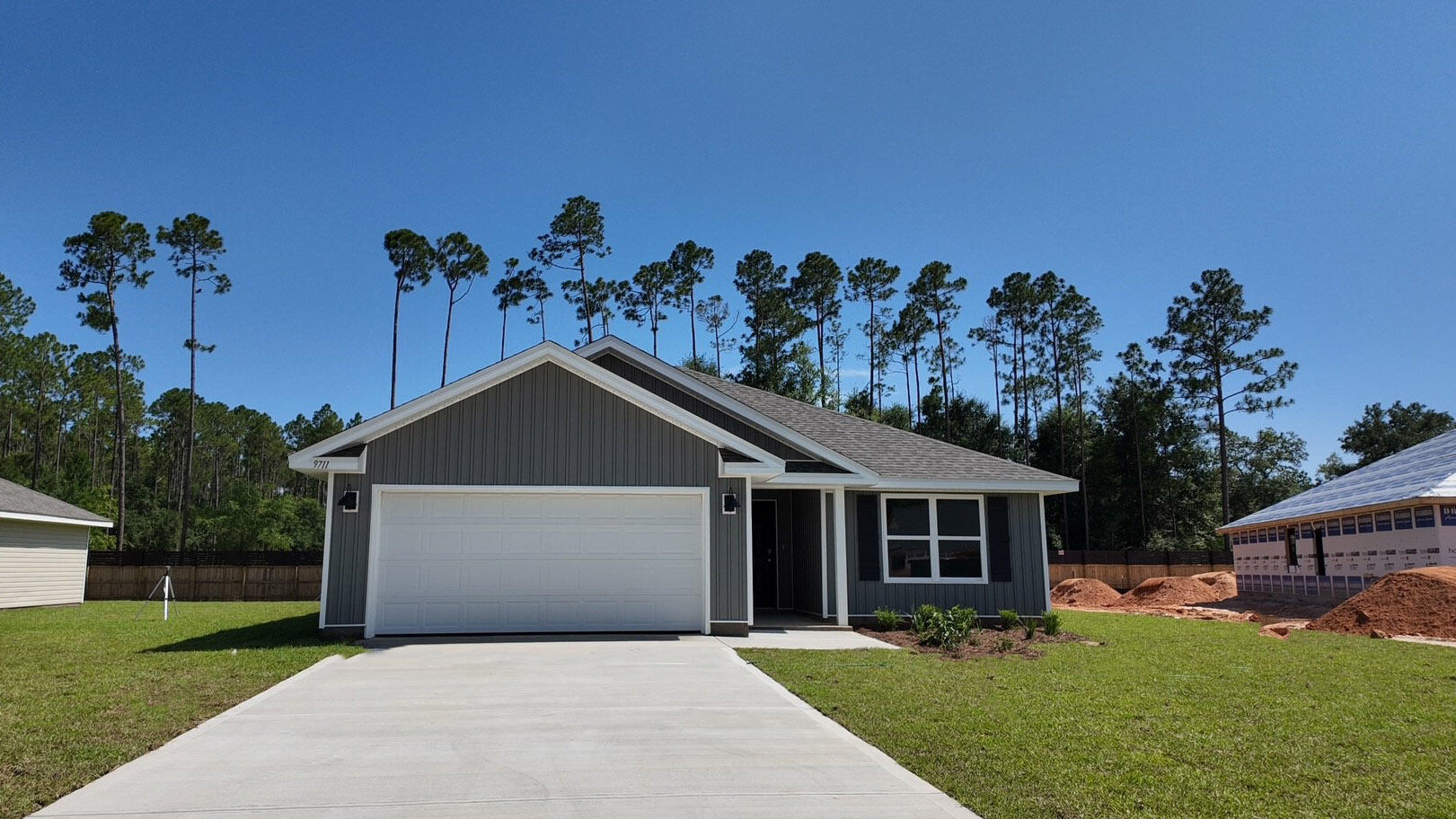 9711 Dutton Lane Milton, FL 32583 - Photo 1 of 27 a front view of a house with a yard and garage