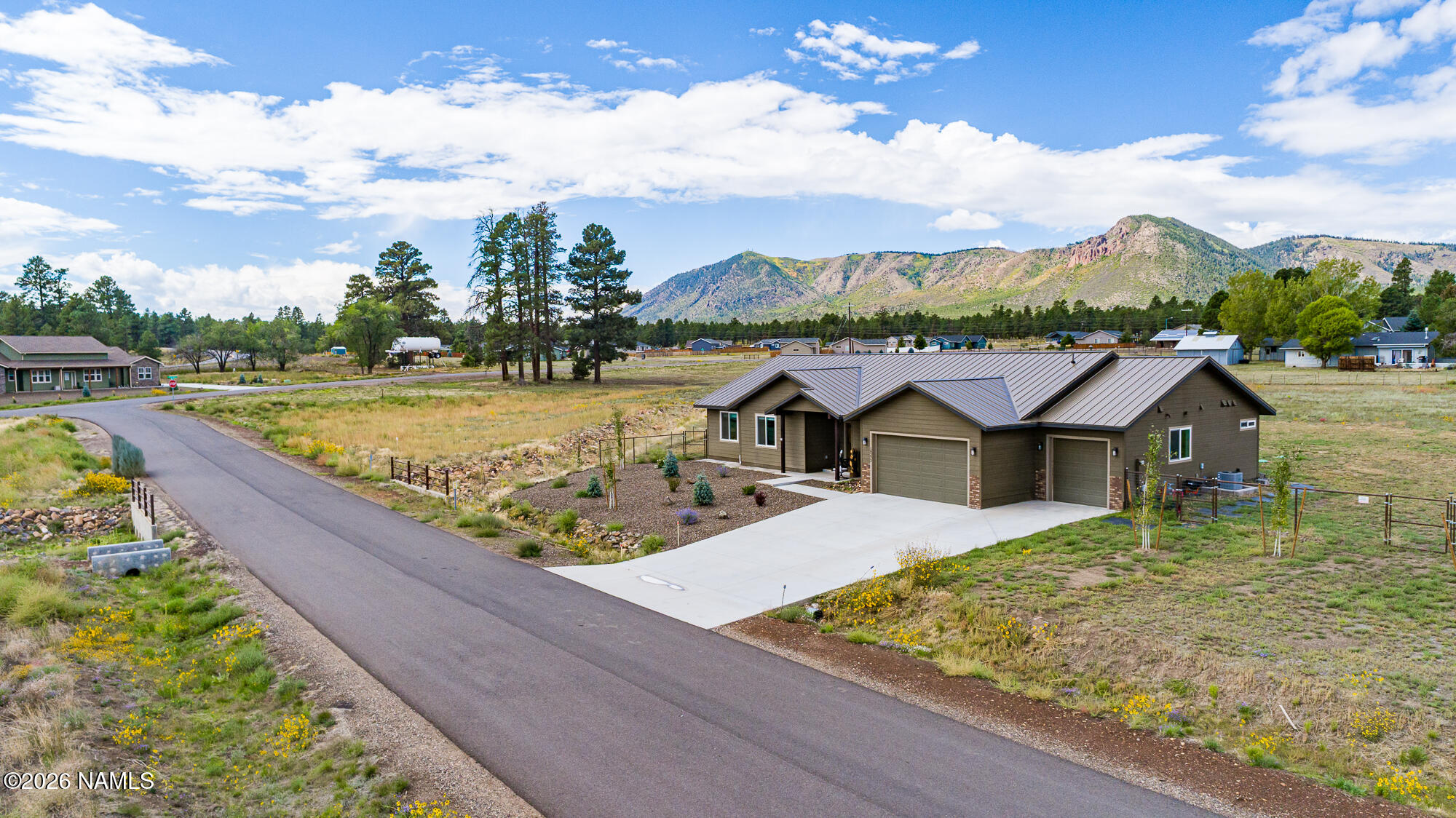 10272 Fw Mclure Road Flagstaff, AZ 86004 - Photo 18 of 38 a view of a house with pool and mountains in the background
