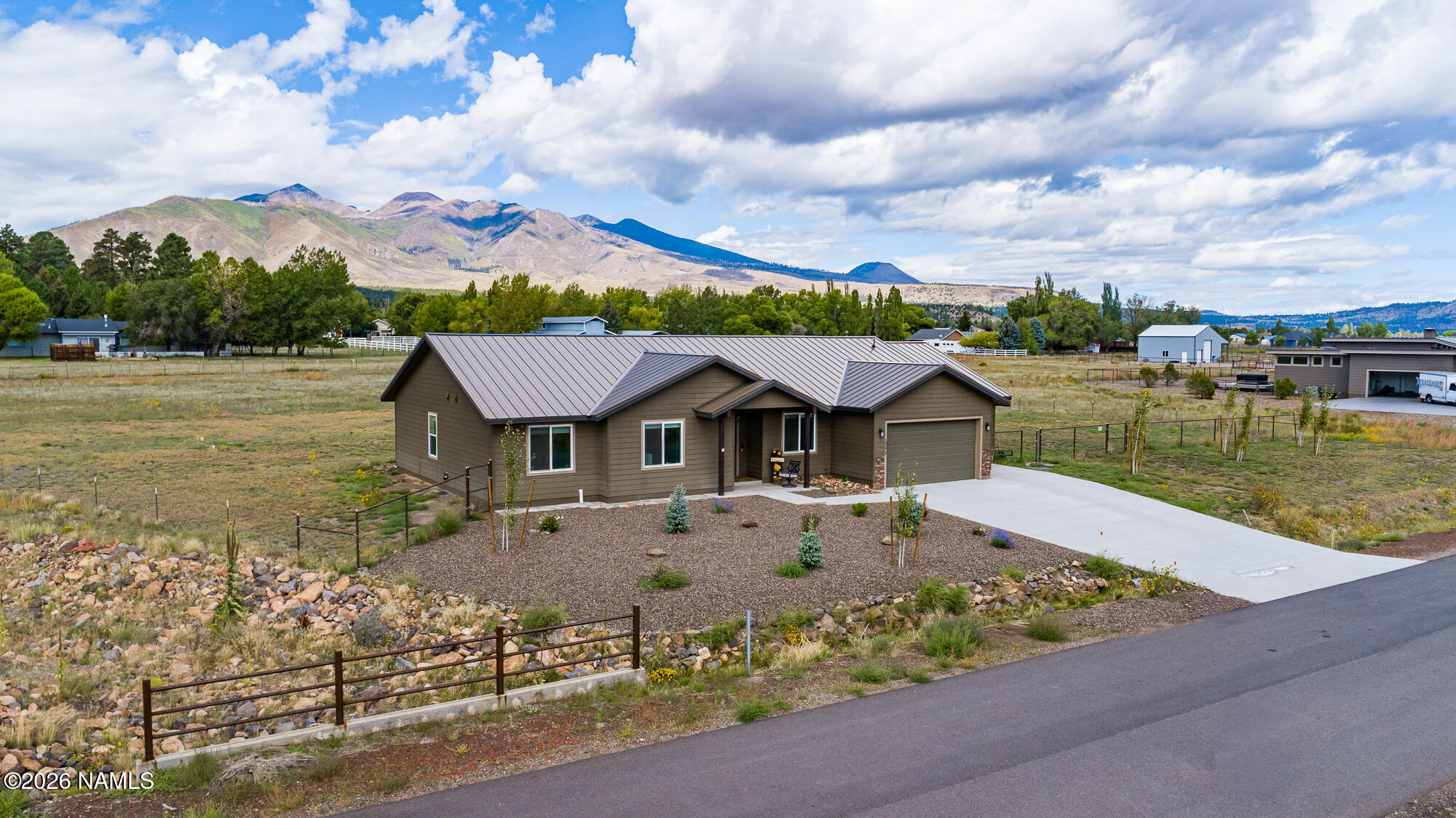 10272 Fw Mclure Road Flagstaff, AZ 86004 - Photo 22 of 38 a view of a big house with a big yard and large tree