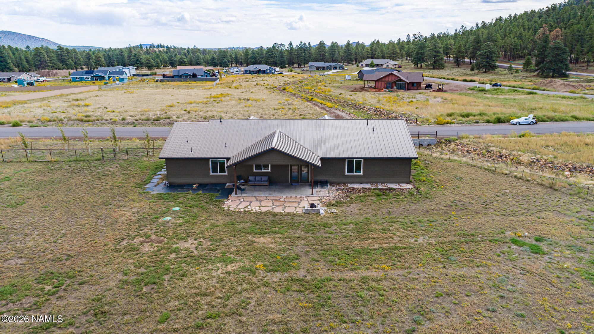 10272 Fw Mclure Road Flagstaff, AZ 86004 - Photo 26 of 38 a view of a lake with lawn chairs and large trees