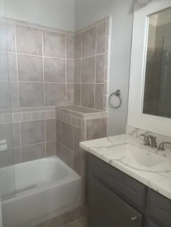 a bathroom with a granite countertop sink a toilet and shower