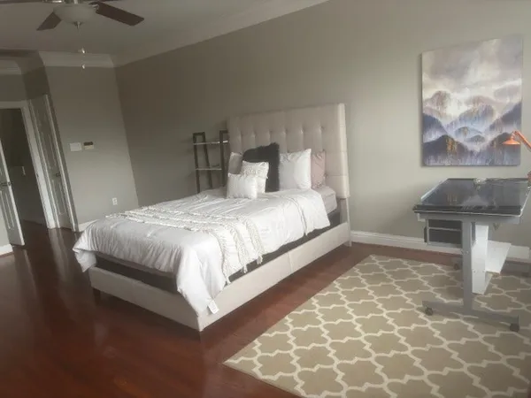 a bedroom with a bed and a chair