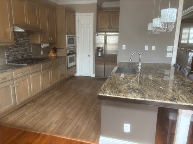 1333 Fairview Street Houston, TX 77006 - Photo 4 of 27 a kitchen with kitchen island granite countertop a sink a stove and cabinets