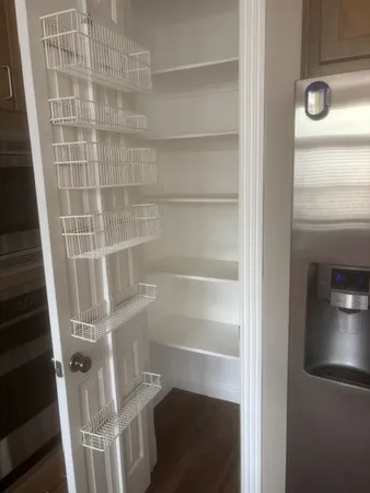 a view of walk in closet with empty racks